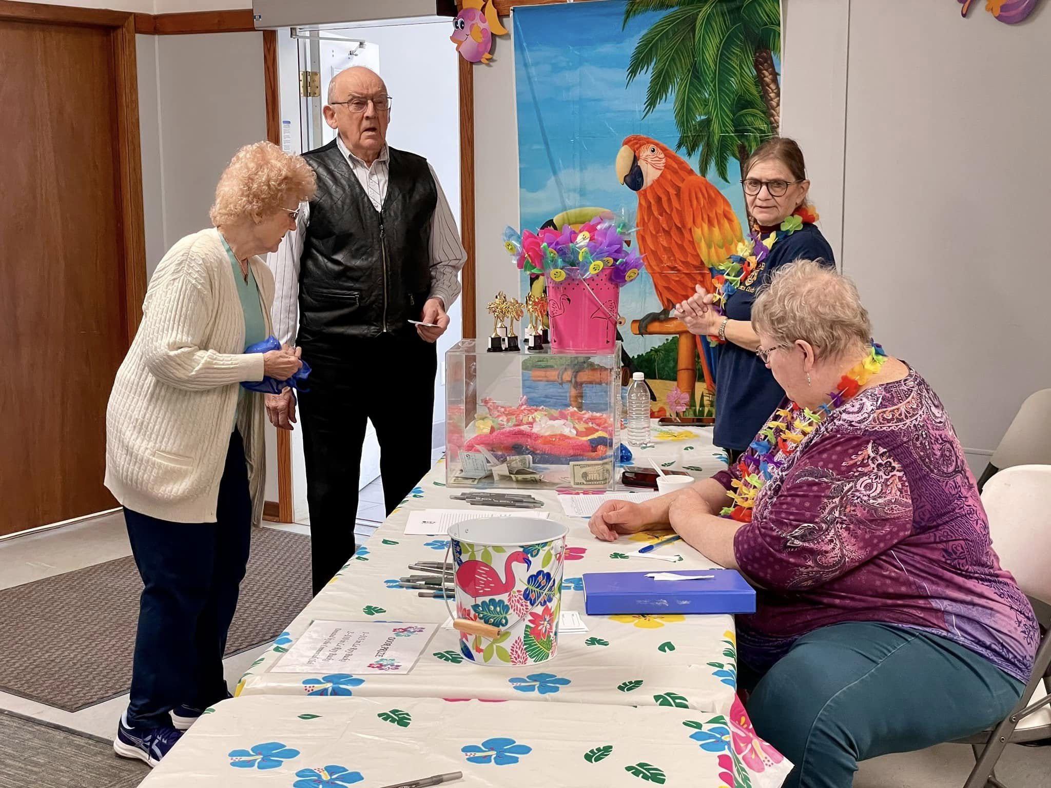 A man and woman checking in at an event registration desk.